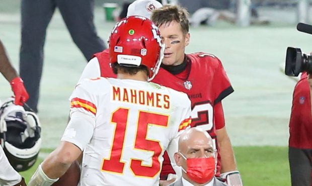 Tom Brady (12) of the Buccaneers shakes hands with Patrick Mahomes (15) of the Chiefs after the reg...