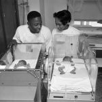 Hank Aaron, Milwaukee Braves outfielder and his wife Barbara look at twin boys born 12/15 at St. Anthony Hospital. Larry (L) weighed 3 lbs 6oz and Gary, 3lbs 7oz. They are shown in incubator.