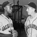 Henry Aaron, l, second baseman with the Jacksonville, Fl, Tars, selected as Most Valuable Player in the Sally League for 1953, is shown talking with the Tars skipper Ben Geraghty after the announcement today.