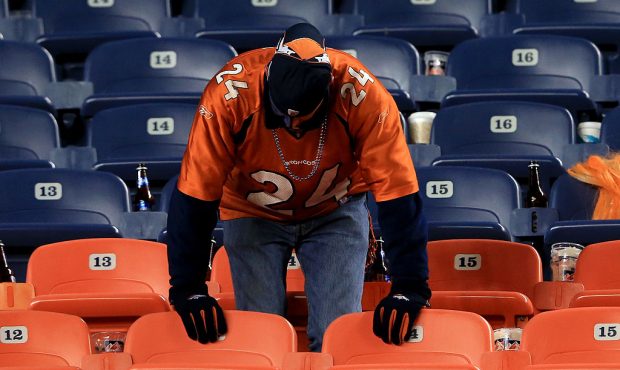 DENVER, CO - JANUARY 12: A dejected fan of the Denver Broncos stands in the seats after the Baltimo...