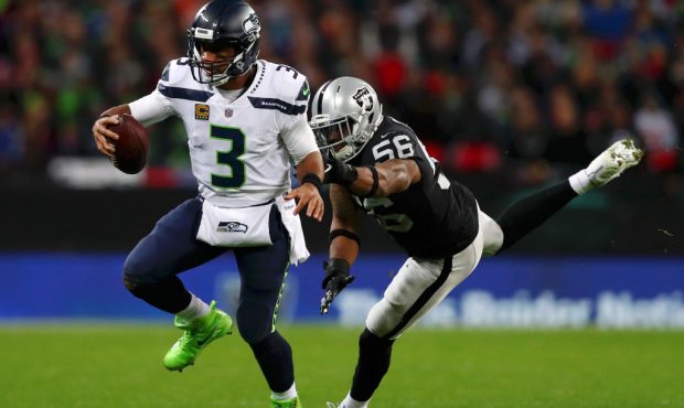 LONDON, ENGLAND - OCTOBER 14: Derrick Johnson of Oakland Raiders tackles Russell Wilson during the ...