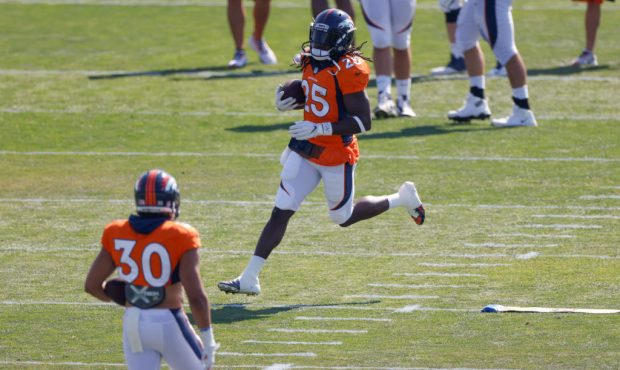 ENGLEWOOD, CO - AUGUST 18: Running back Melvin Gordon #25 of the Denver Broncos runs with the footb...