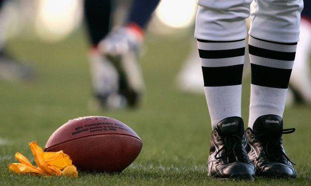DENVER - JANUARY 22: A yellow penalty flag lays on the field near the football during the AFC Champ...