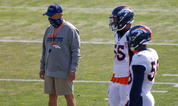 ENGLEWOOD, CO - AUGUST 18: Head coach Vic Fangio of the Denver Broncos stands nearby linebacker Bra...