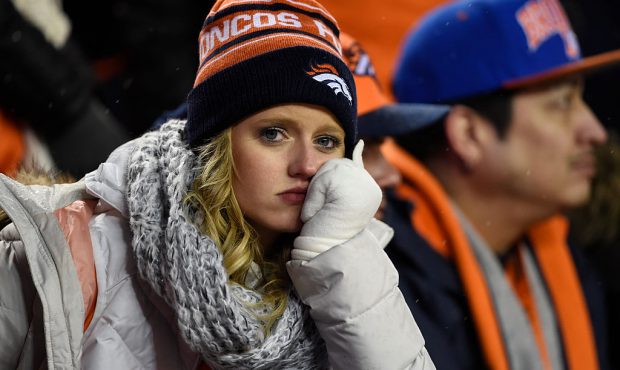 DENVER, CO - JANUARY 11: Broncos fans sit dejected in the fourth quarter. The Denver Broncos played...