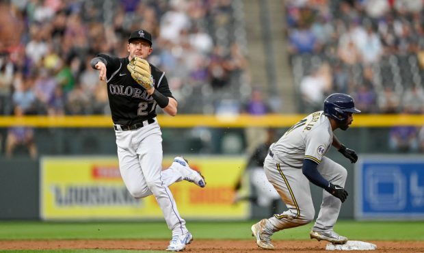 DENVER, CO - JUNE 17: Trevor Story #27 of the Colorado Rockies throws to first base on a double pla...