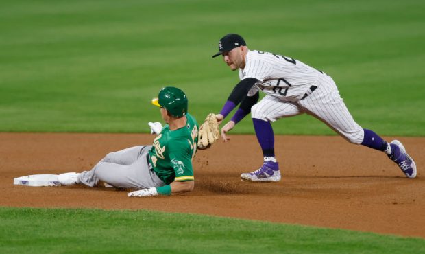 DENVER, CO - SEPTEMBER 15: Jake Lamb #4 of the Oakland Athletics slides in safely with a double ahe...