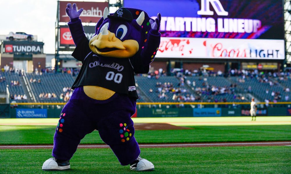 Video shows fan tackling Rockies mascot Dinger on top of dugout