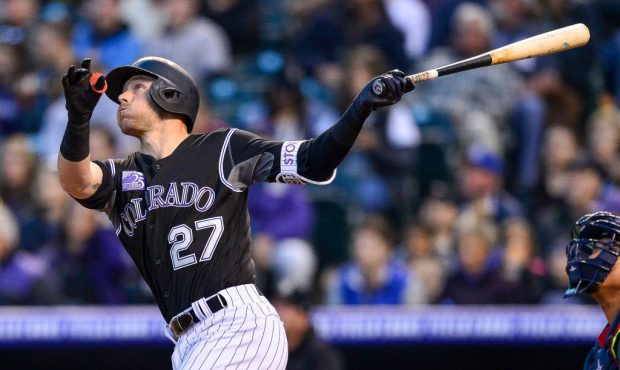 DENVER, CO - APRIL 7: Trevor Story #27 of the Colorado Rockies watches the flight of a fourth innin...