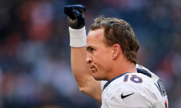 HOUSTON, TX - DECEMBER 22: Peyton Manning #18 of the Denver Broncos celebrates after throwing his f...