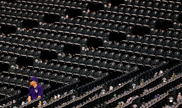 DENVER, CO - JULY 7: An usher sits among the empty seats during the eighth inning after a rain dela...