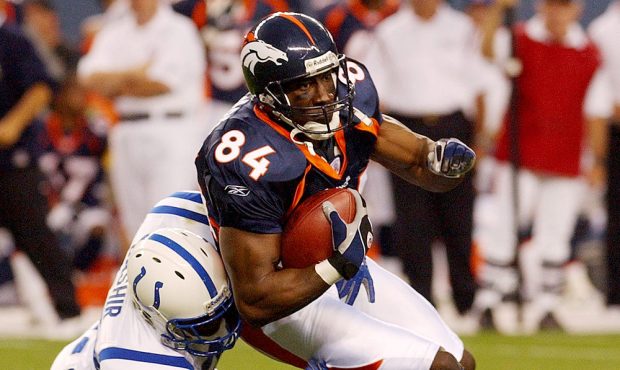 Denver Broncos tight end Shannon Sharpe is tackled by the Indianapolis Colts Idrees Bashir, 28, dur...