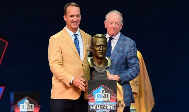 Peyton Manning and his father Archie Manning pose after unveiling his bust during the NFL Hall of F...