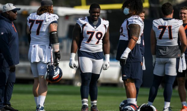 ENGLEWOOD , CO - AUGUST 2: Lloyd Cushenberry (79) of the Denver Broncos jokes with fellow offensive...