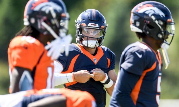 EAGAN, MN - AUGUST 11: Drew Lock (3) of the Denver Broncos stretches with Teddy Bridgewater (5) and...