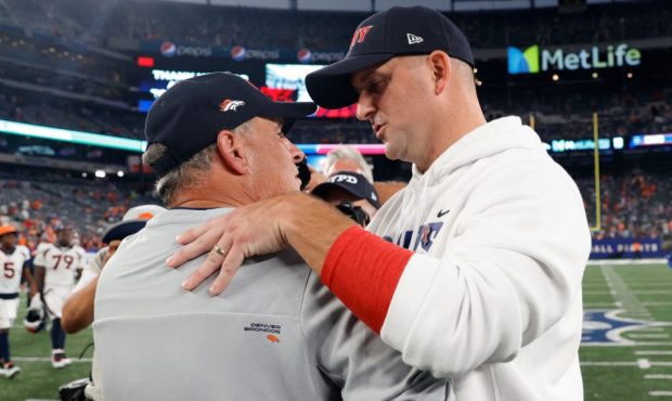 EAST RUTHERFORD, NEW JERSEY - SEPTEMBER 12: Head coach Vic Fangio of the Denver Broncos shakes hand...