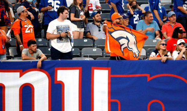 EAST RUTHERFORD, NEW JERSEY - SEPTEMBER 12: A Denver Bronco fan holds a flag during the game betwee...