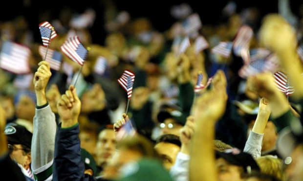 01 Oct 2001: Fans wave flags to show support for the victims of the September 11 disaster during th...