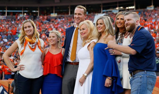 DENVER, CO - SEPTEMBER 08: Peyton Manning poses with Annabel Bowlen and other members of the Bowlen...