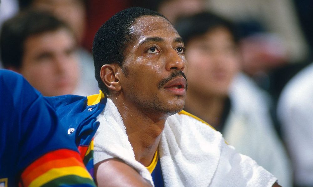 LANDOVER, MD - CIRCA 1990: Alex English #2 of the Denver Nuggets looks on from the bench against th...
