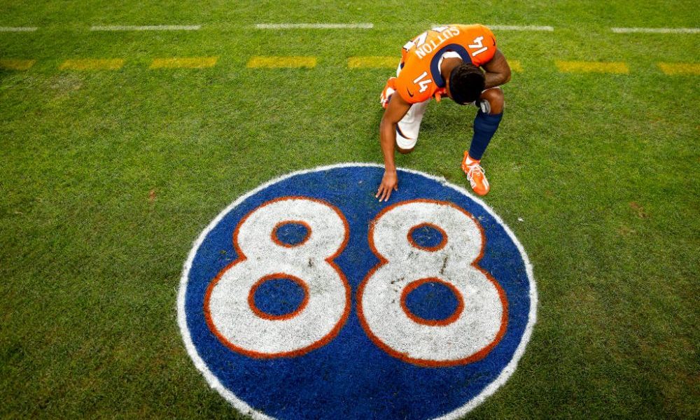 DENVER, COLORADO - DECEMBER 12: Courtland Sutton #14 of the Denver Broncos kneels and takes a momen...