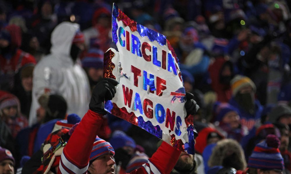 BUFFALO, NEW YORK - JANUARY 15: A Buffalo Bills fan holds a sign that reads, "Circling the Wagons" ...