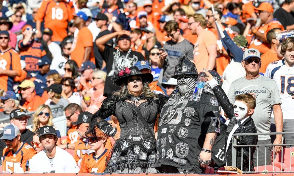 DENVER, CO - OCTOBER 17: A group of costumed Las Vegas Raiders fans looks on from the stands during...