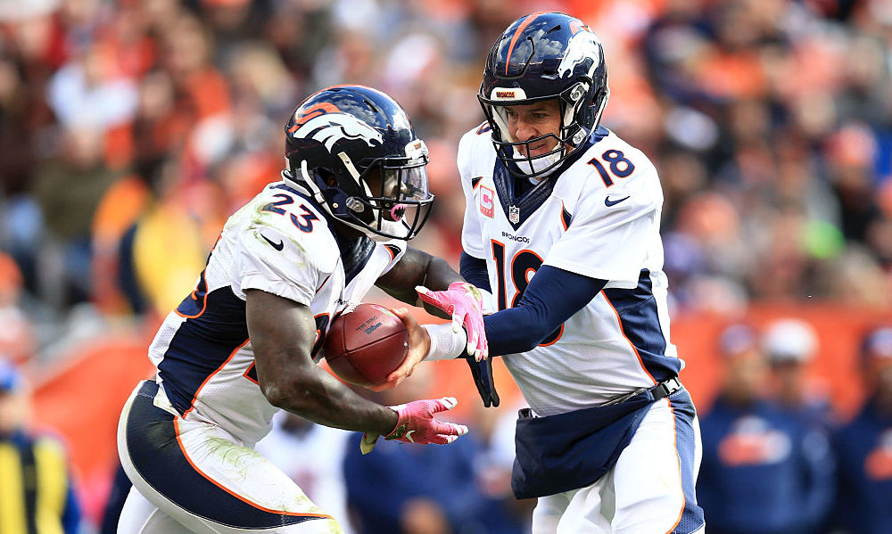 CLEVELAND, OH - OCTOBER 18: Quarterback Peyton Manning #18 of the Denver Broncos hands the ball off...