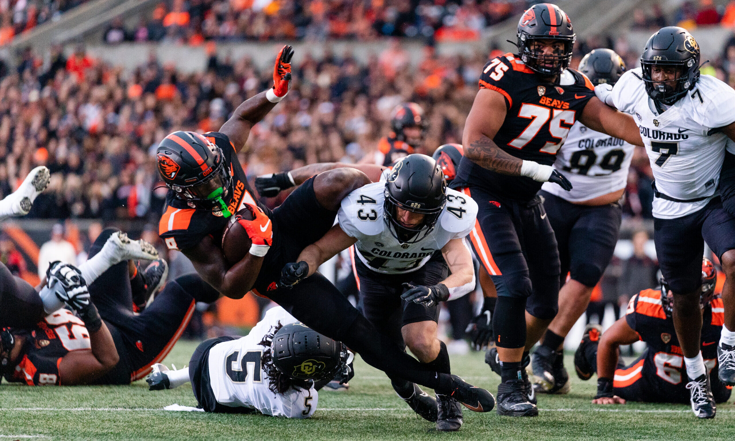 Oregon State Beavers gets tackled by Safety Trevor Woods #43 of the Colorado Buffaloes...