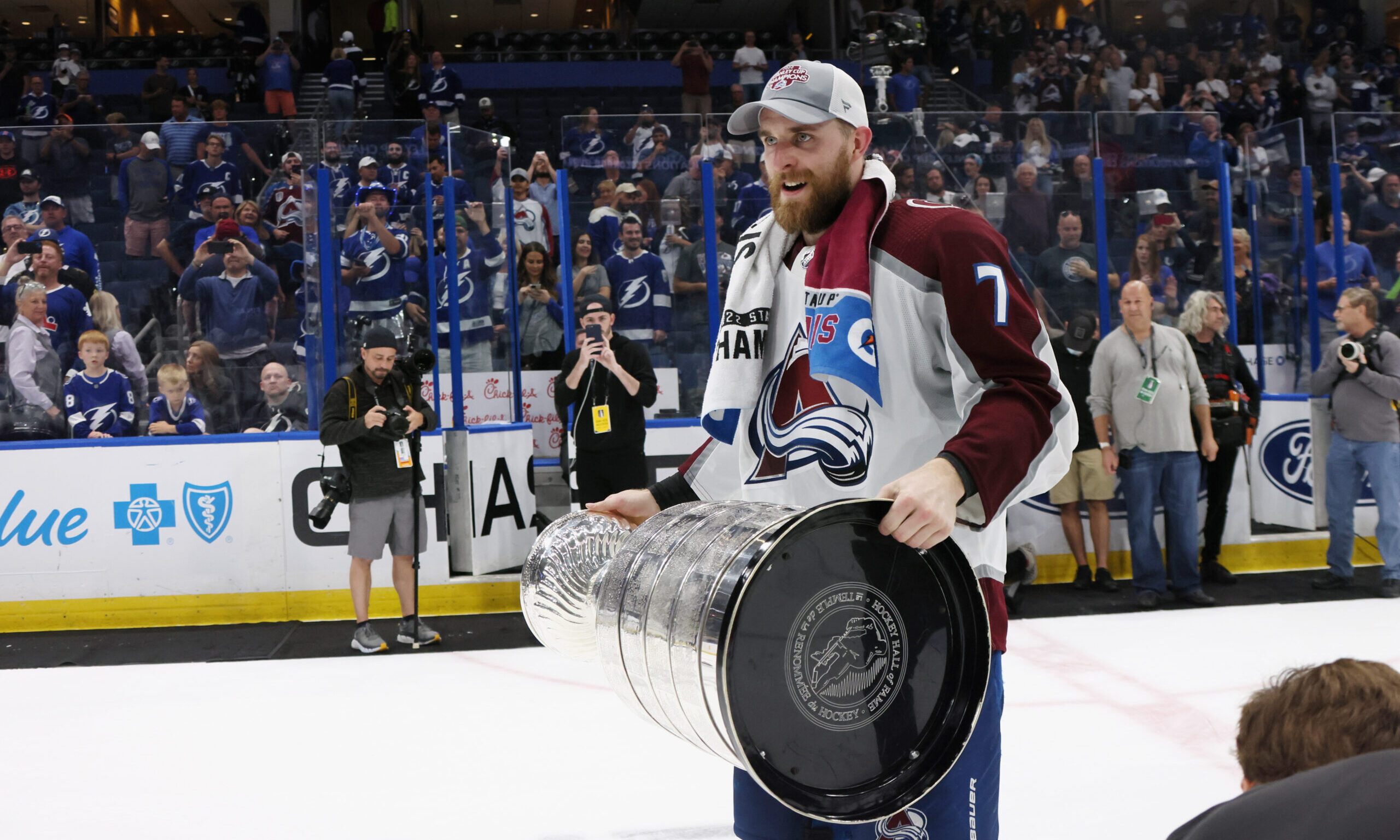 TAMPA, FLORIDA - JUNE 26: Devon Toews #7 of the Colorado Avalanche carries the Stanley Cup followin...