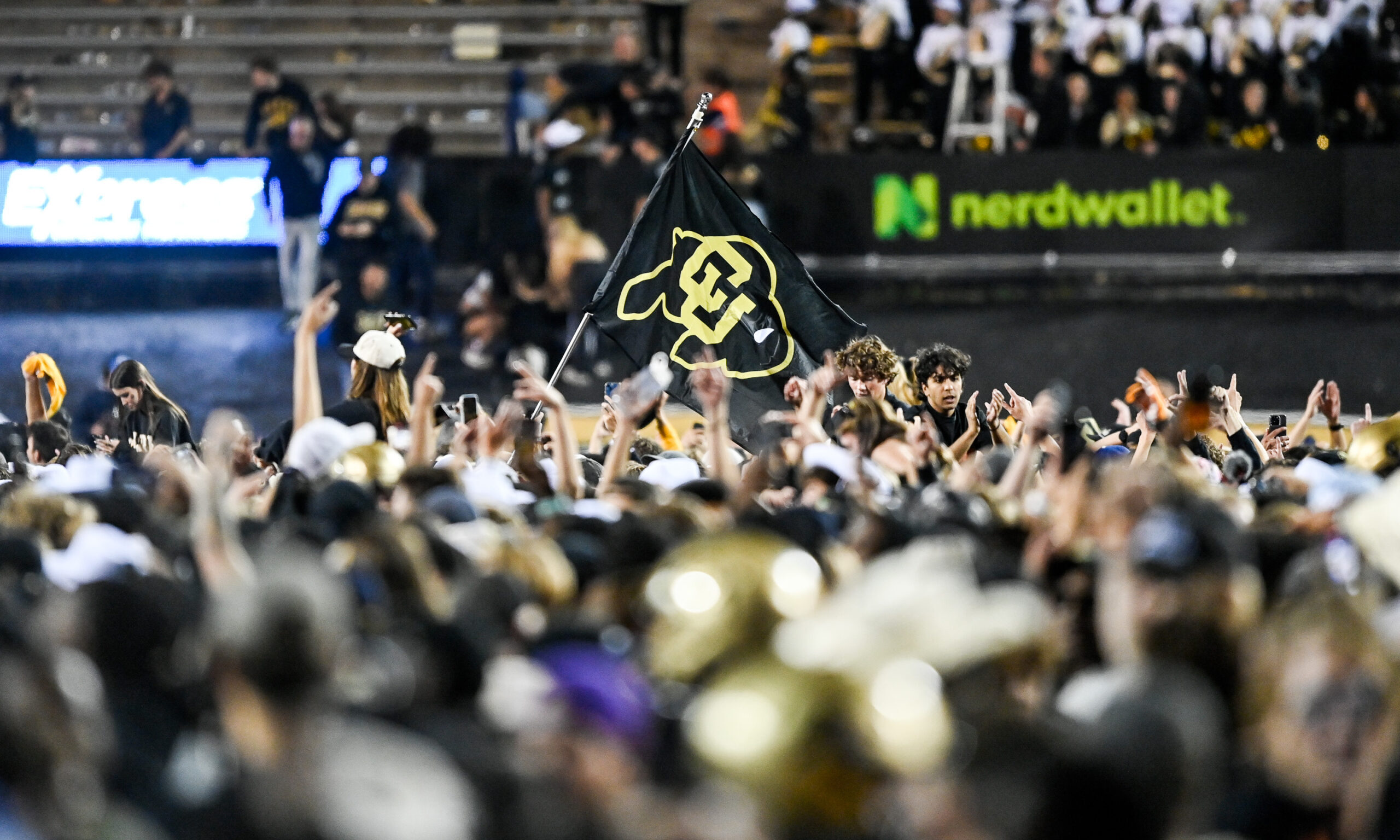 Spectators rush the field after a double overtime win for the Colorado Buffaloes...