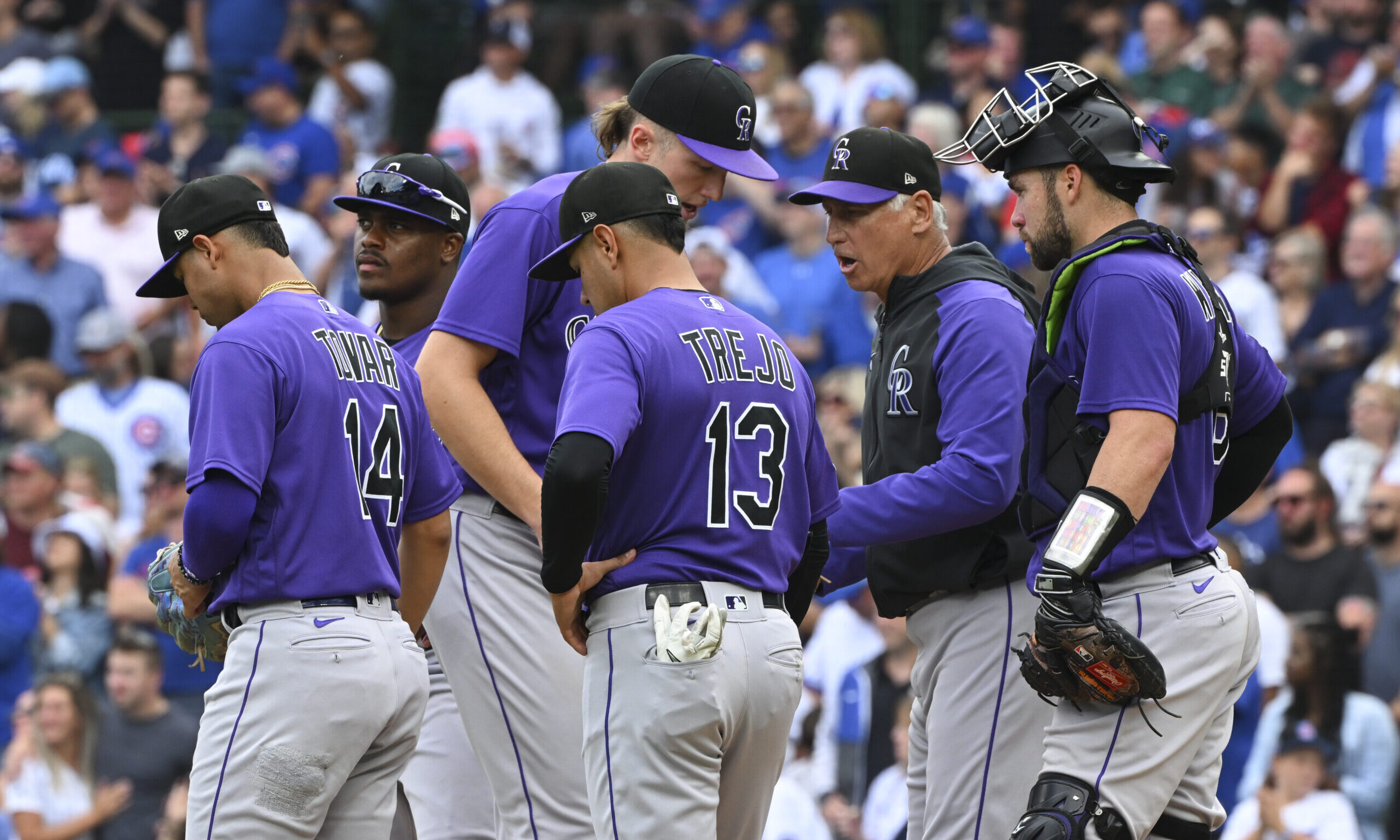Bud Black #10 of the Colorado Rockies visits the mound to make a pitching change...