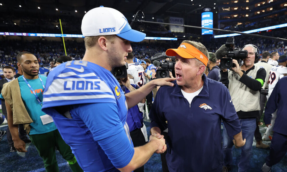 Jared Goff #16 of the Detroit Lions shakes hands with Head Coach Sean Payton of the Denver Broncos...