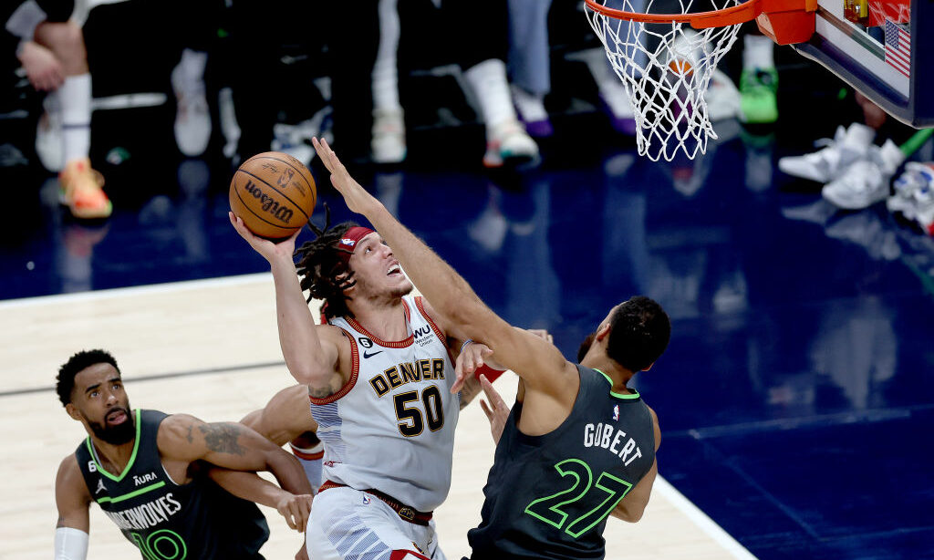 Aaron Gordon #50 of the Denver Nuggets goes to the basket against Rudy Gobert #27 of the Wolves...