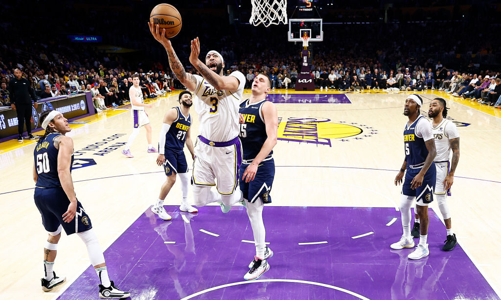 Anthony Davis #3 of the Los Angeles Lakers takes a shot against Nikola Jokic #15 of the Denver Nugg...
