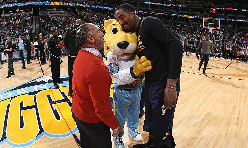 Rocky the mascot for the Denver Nuggets greet J.R. Smith #5 of the Cleveland Cavaliers...