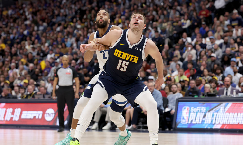 Nikola Jokic #15 of the Denver Nuggets boxes out Rudy Gobert #27 of the Minnesota Timberwolves...
