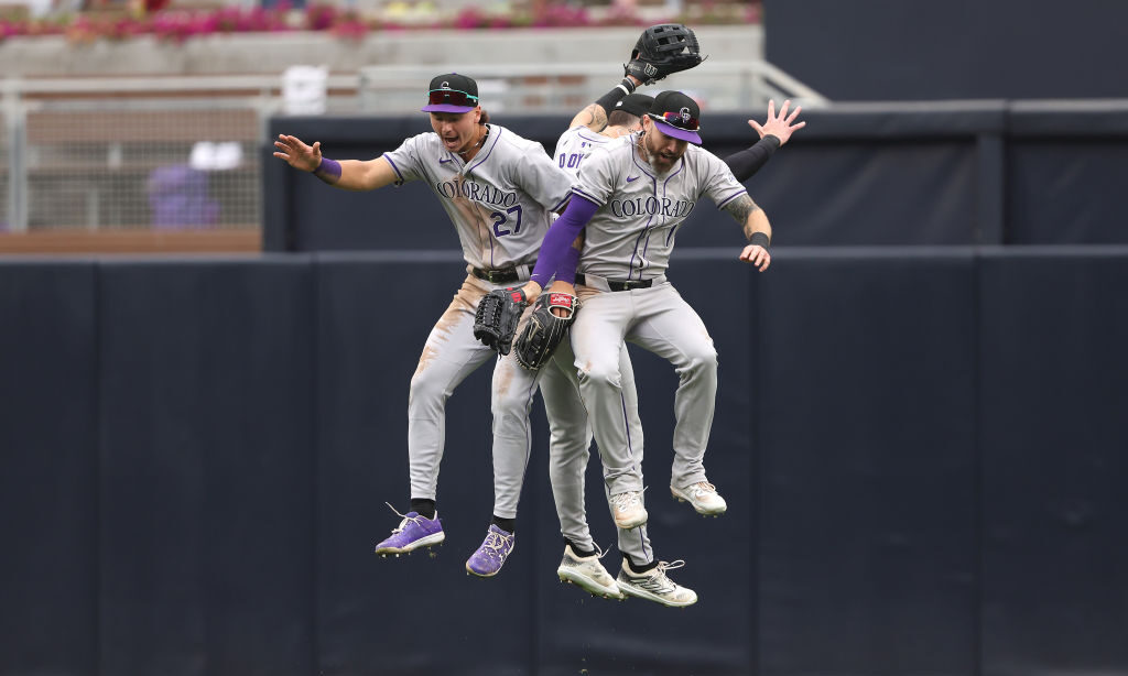 Jordan Beck #27, Jake Cave #11 and Brenton Doyle #9 of the Colorado Rockies...