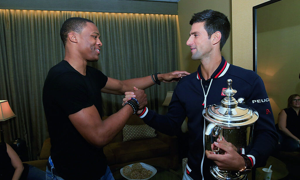 Novak Djokovic of Serbia, the 2015 US Open Men's Singles champion, meets (L) NBA player Russell Wes...
