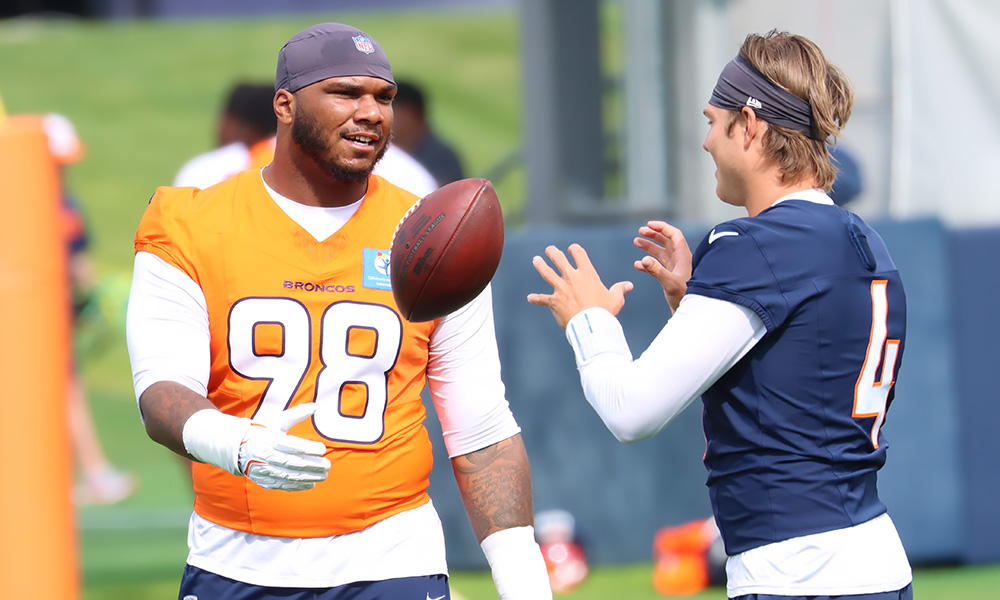 Broncos DL John Franklin-Myers and QB Zach Wilson...