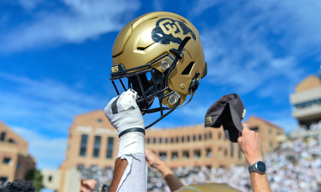 BOULDER, CO - OCTOBER 15:  A Colorado Buffaloes helmet is held in the air as Colorado Buffaloes pla...