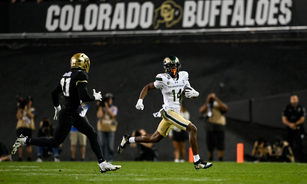 Wide receiver Tory Horton #14 of the Colorado State Rams carries the ball after a catch as safety S...