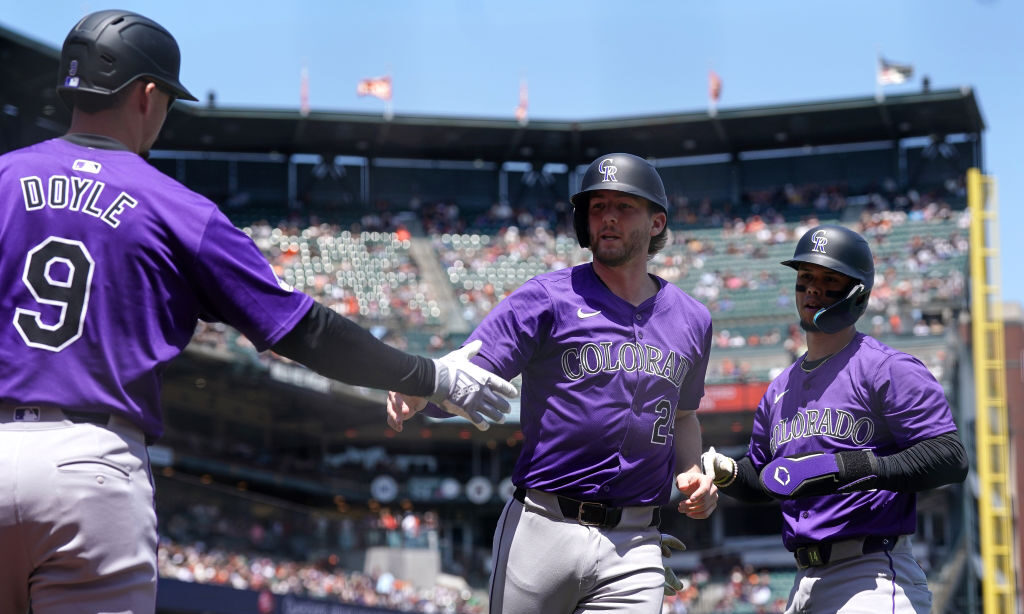 McMahon #24 and Ezequiel Tovar #14 of the Colorado Rockies celebrate scoring a run against the San ...