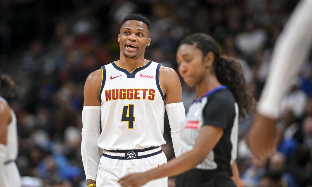 Russell Westbrook (4) of the Denver Nuggets talks to Nikola Jokic (15) during the third quarter aga...