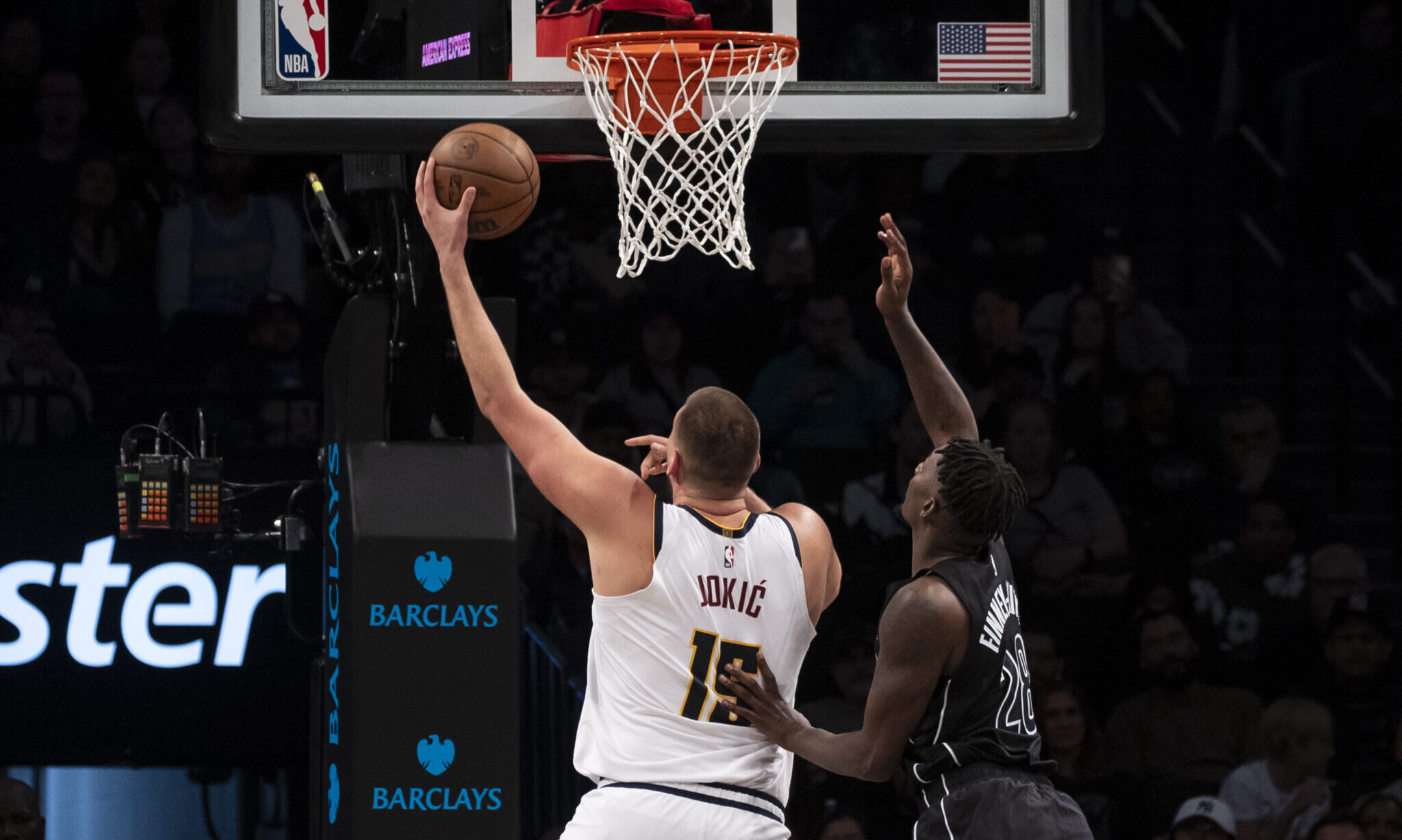 Nikola Jokic #15 of the Denver Nuggets makes a shot over Dorian Finney-Smith...