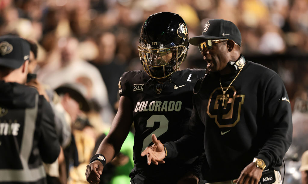 Shedeur Sanders #2 and head coach Deion Sanders of the Colorado Buffaloes...