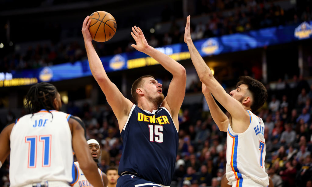 Nikola Jokic #15 of the Denver Nuggets drives against Chet Holmgren #7 of the Oklahoma City Thunder...