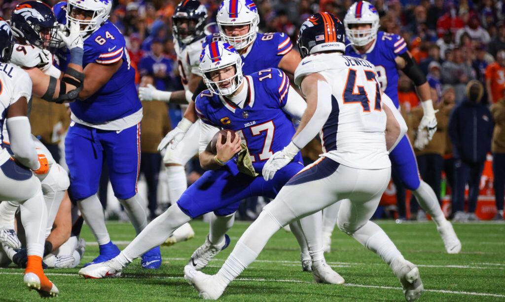 Josh Allen #17 of the Buffalo Bills carries the ball against the Denver Broncos...