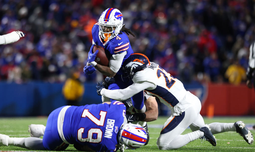 James Cook #4 of the Buffalo Bills carries the ball against the Denver Broncos...