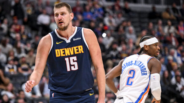 Nikola Jokic (15) of the Denver Nuggets reacts after giving up a bucket to Shai Gilgeous-Alexander (2) of the Oklahoma City Thunder during the first quarter at Ball Arena in Denver—the two are leading the NBA MVP race
